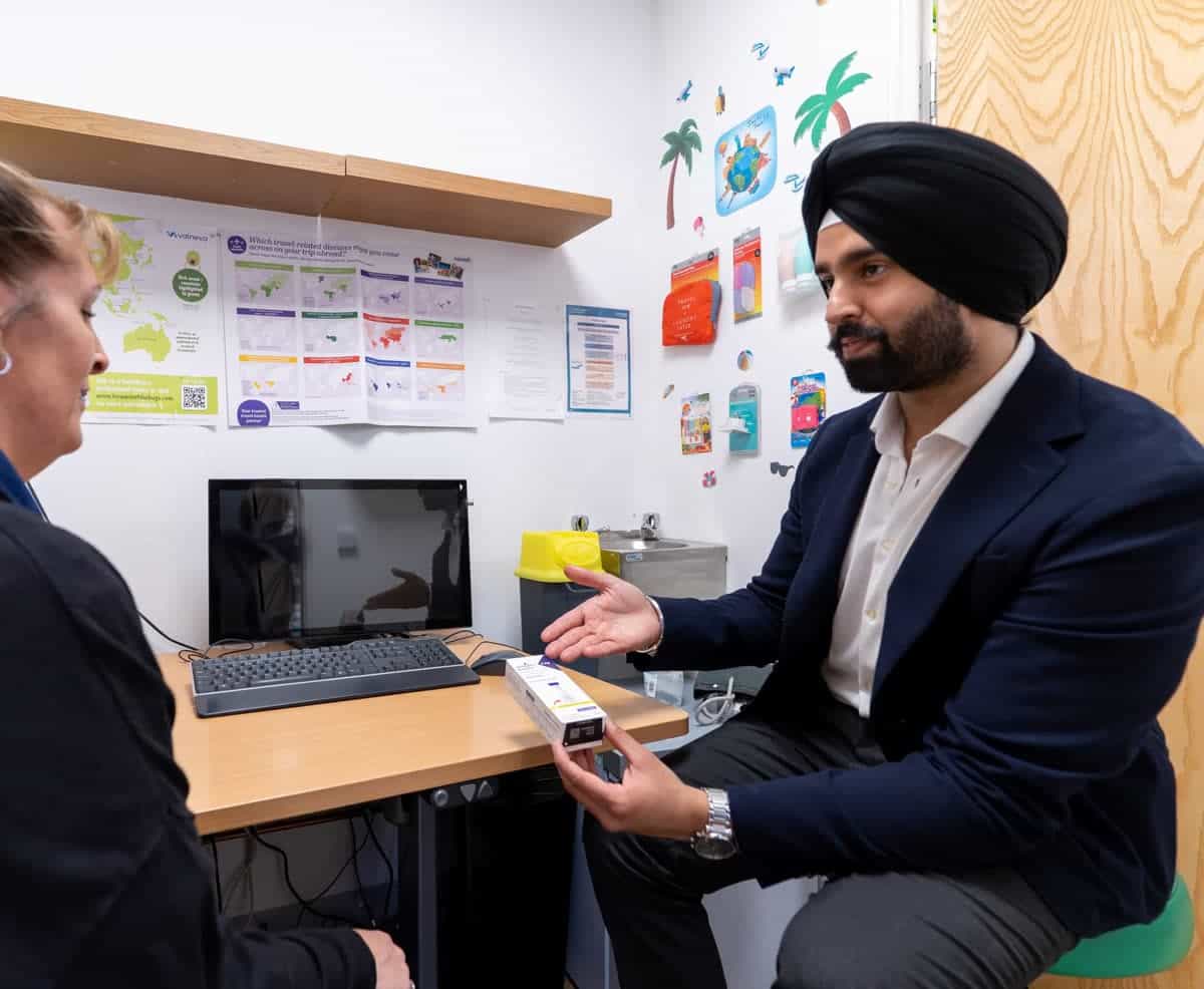 A MediPill pharmacist talking a patient through a test in the private consultation room