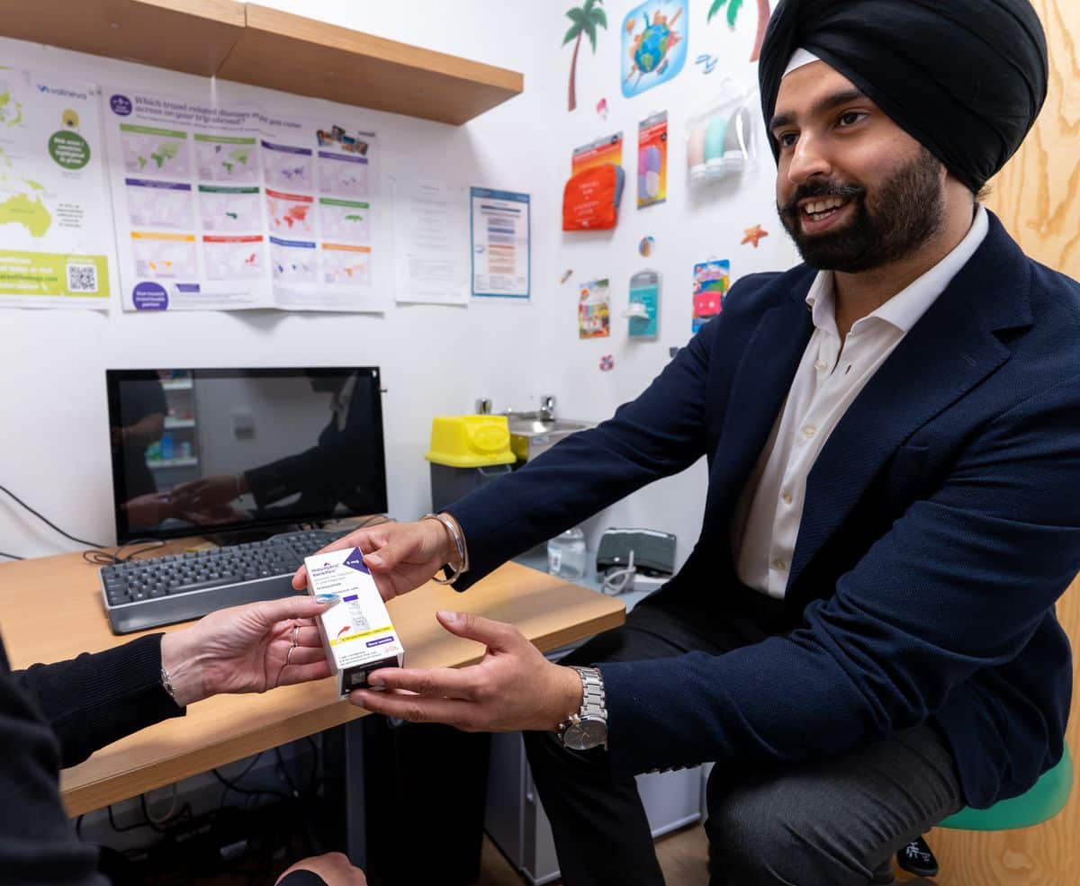 A MediPill pharmacist handing over a prescription