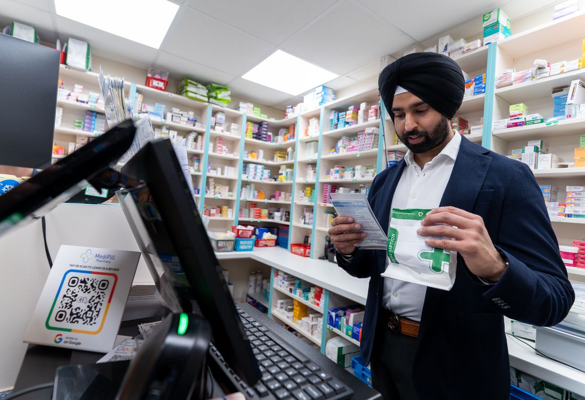 A MediPill pharmacist checking a medicine pack in the dispensary