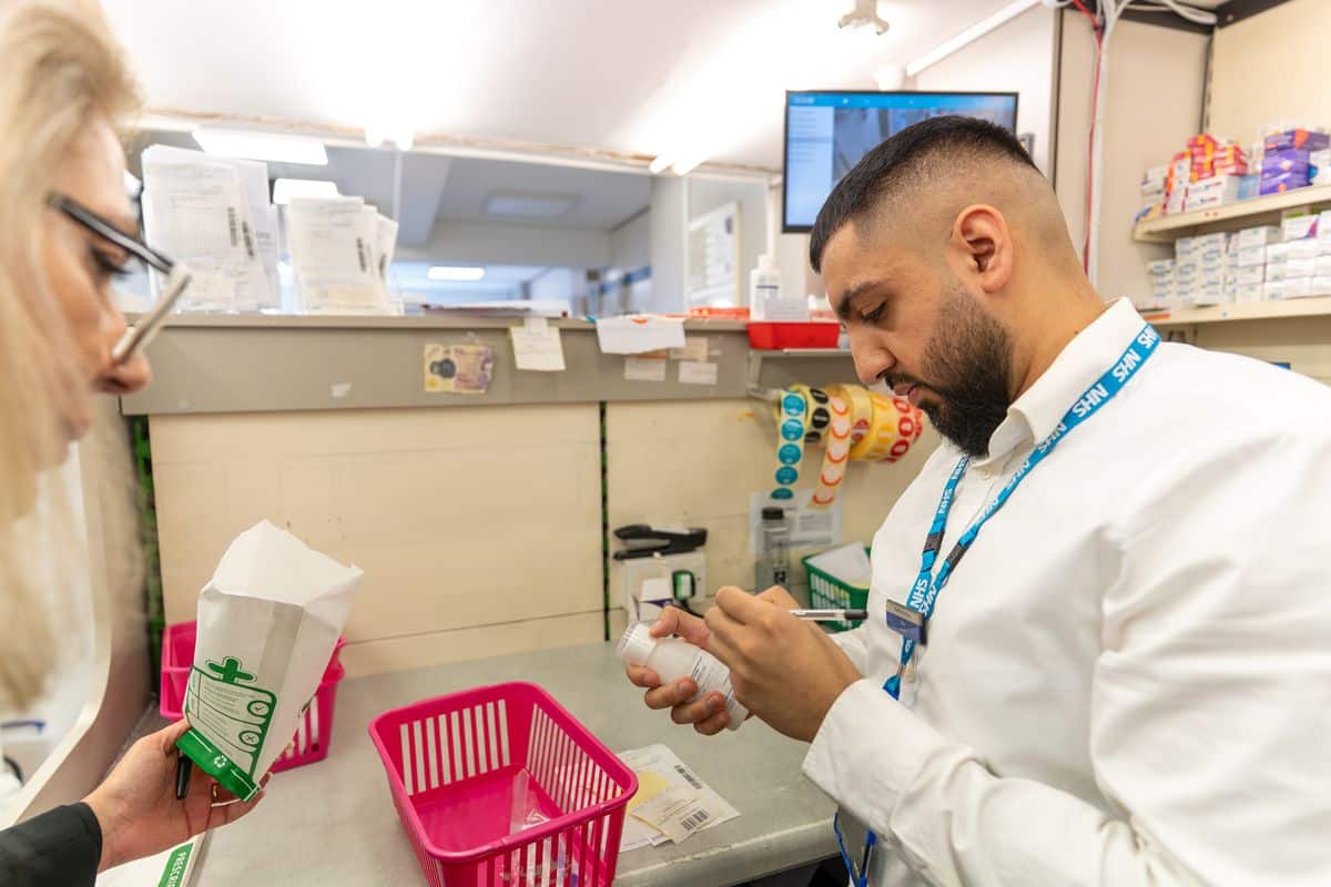 A MediPill pharmacist checking a prescription in the dispensary