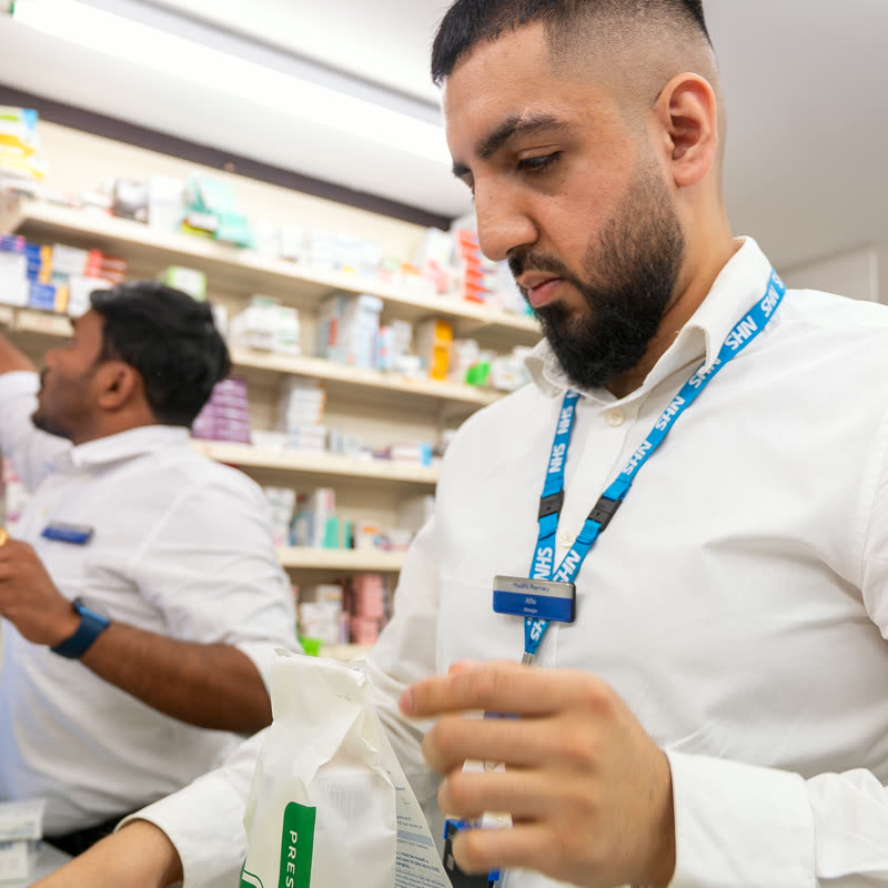 Pharmacist checking a dispensed prescription at MediPill Summertown